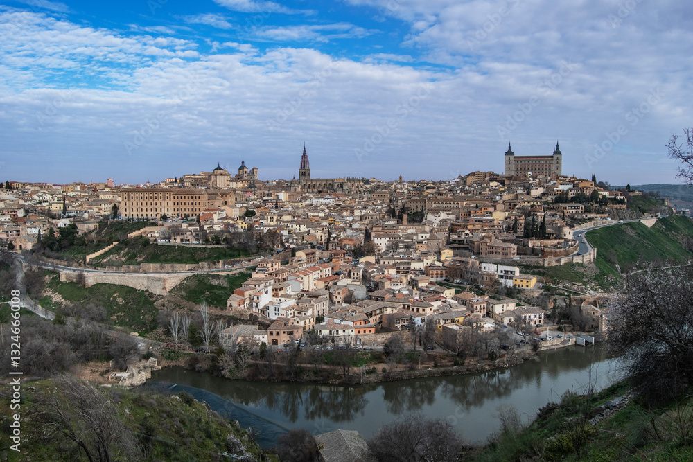 View of the city of Toledo with the Alcazar and the Cathedral and the Tajo River bordering the city View of the city of Toledo with the Alcazar and the Cathedral and the Tajo River bordering the city