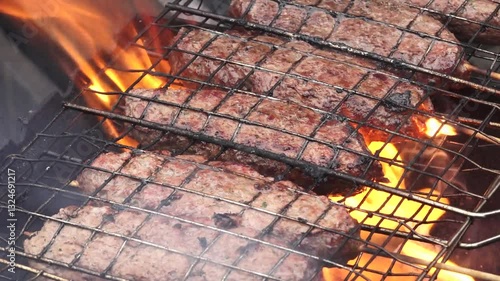 Close up of sausages being grilled on an outdoor fire