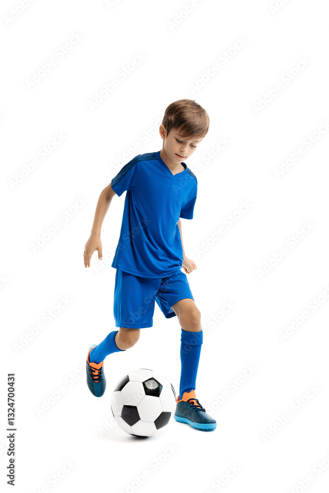 Diligent young boy in blue sport outfit playing with classic soccer ball over white background Diligent young boy in blue sport outfit playing with classic soccer ball over white background