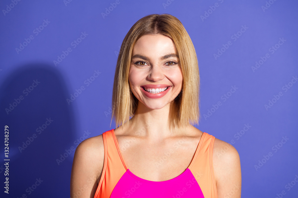 Portrait of a smiling young blond woman wearing colorful sportswear against a bright purple background, exuding confidence and style Portrait of a smiling young blond woman wearing colorful sportswear against a bright purple background, exuding confidence and style