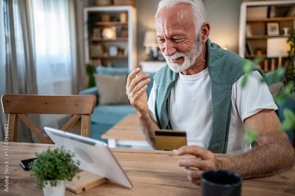 Senior man using tablet and credit card for online shopping at home Senior man using tablet and credit card for online shopping at home