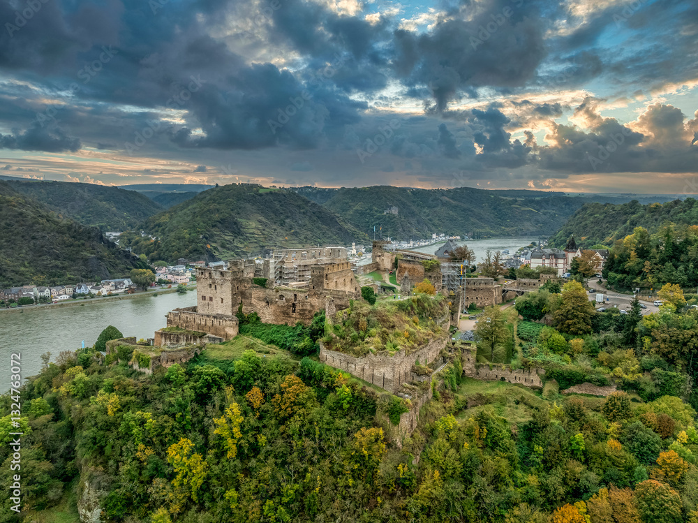 Aerial view of Rheinfels castle medieval ruin under reconstruction in Germany with dramatic sunset sky