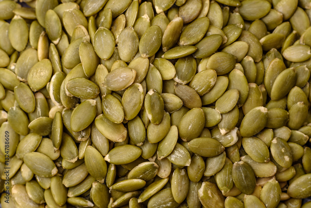 Peeled pumpkin seeds in a bowl, an ingredient for making vegetarian food Peeled pumpkin seeds in a bowl, an ingredient for making vegetarian food