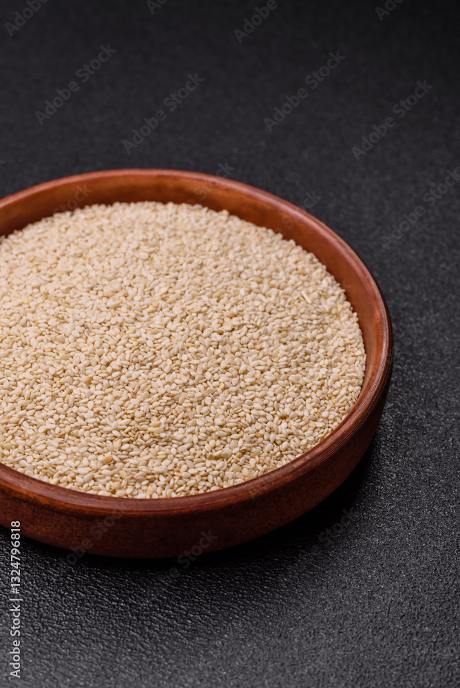 White sesame seeds in a bowl, an ingredient for making vegetarian food White sesame seeds in a bowl, an ingredient for making vegetarian food