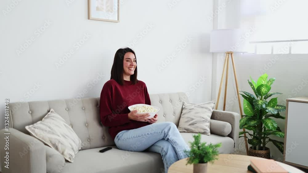 Young woman enjoying relaxed time watching tv at home Young woman enjoying relaxed time watching tv at home