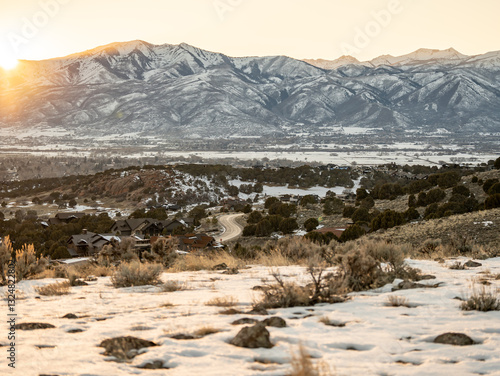 Utah Snow covered mountain range at sunrise with residential area below Heber UT