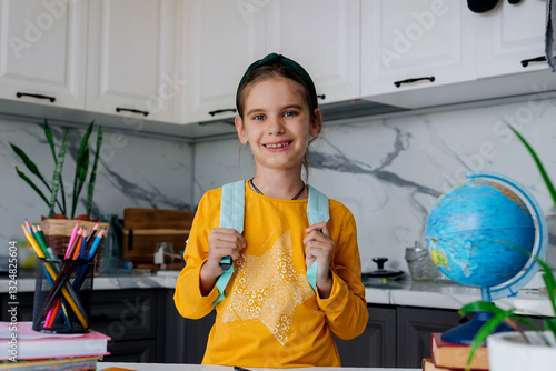 Back to school. Happy cute girl 8 y.o. is going to school early on a sunny morning.
