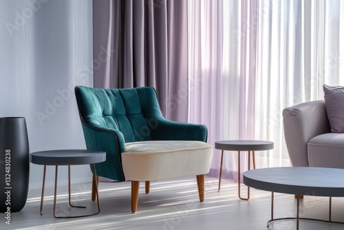 A living room featuring a plush armchair in teal and ivory, with elegant wooden legs, flanked by twin metallic coffee tables to the right