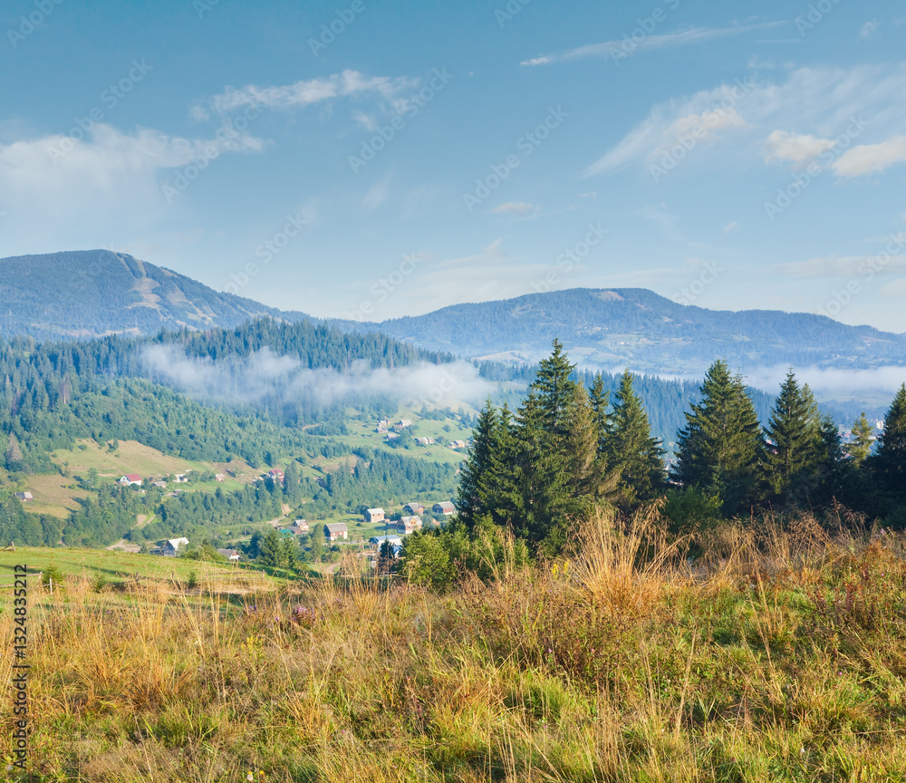 Autumn countryside landscape with village on mountainside