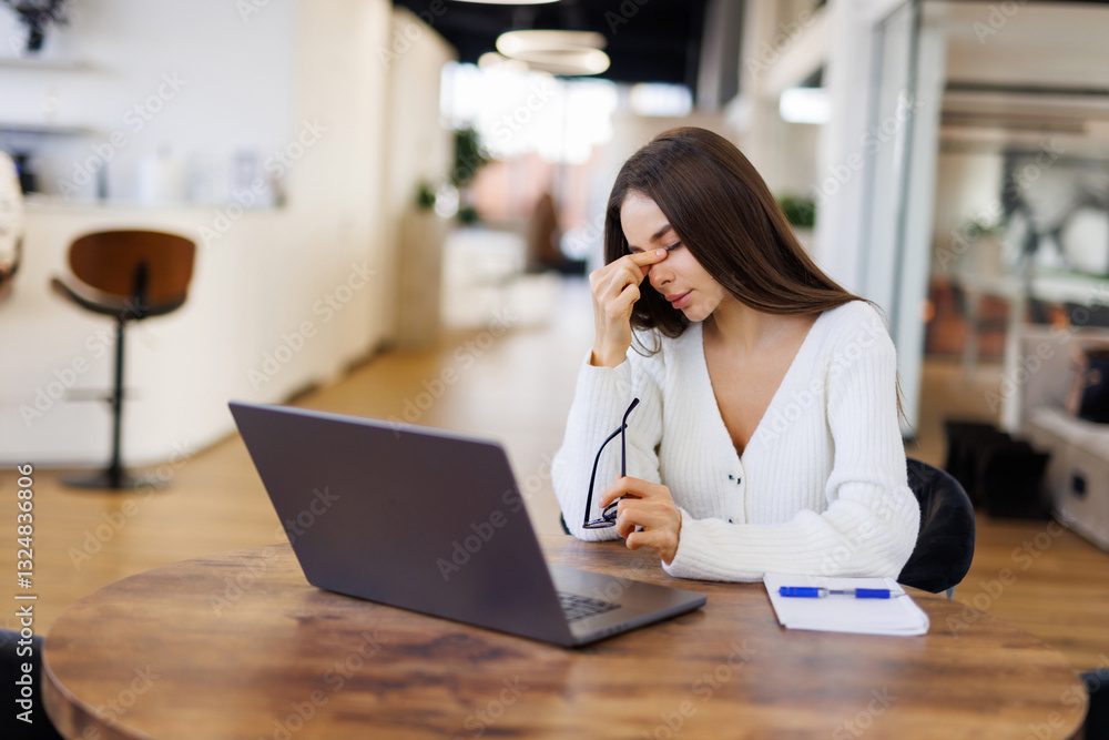 Tired business woman sleepy and bored from sitting at a desk for a long time and has office syndrome Tired business woman sleepy and bored from sitting at a desk for a long time and has office syndrome