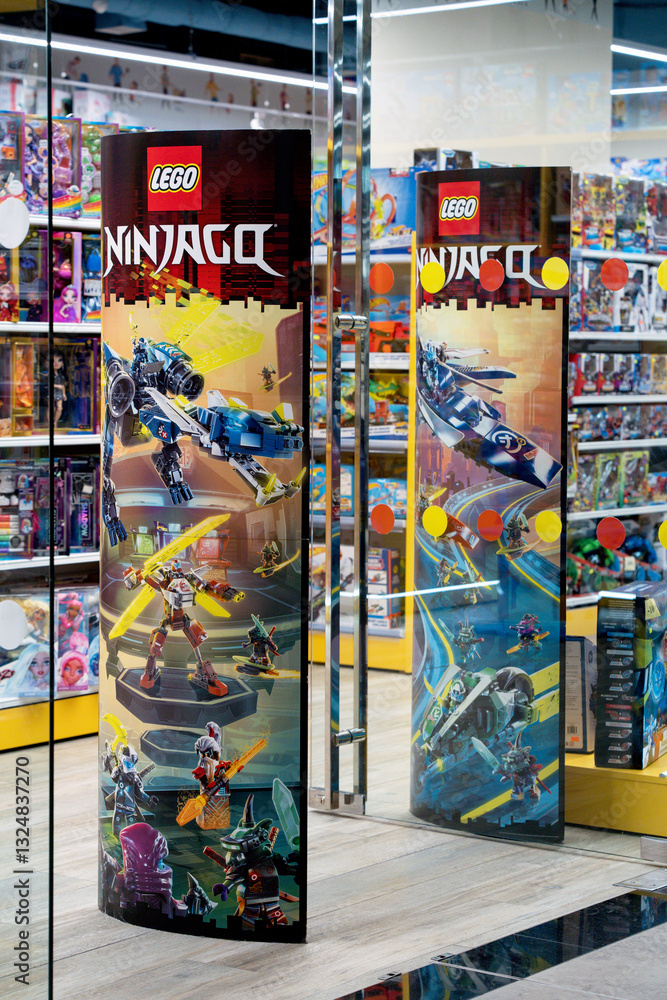 Naklejka premium Lego company advertising at the entrance to a toy store. Lego company logo on a promotional post. Minsk, Belarus - March 4, 2025
