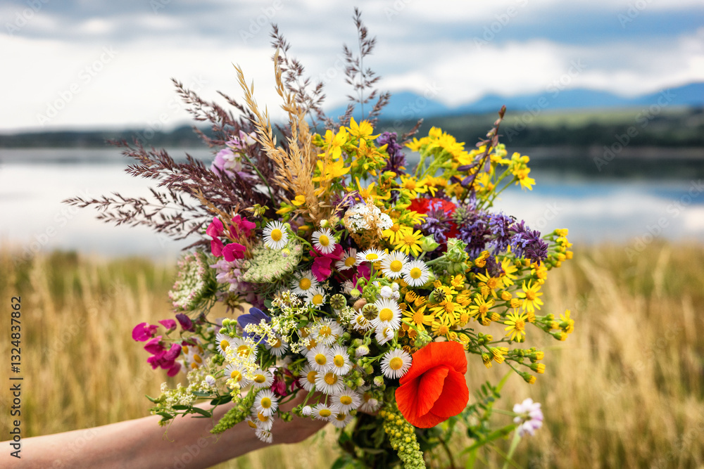 A bouquet of colorful wildflowers in hand