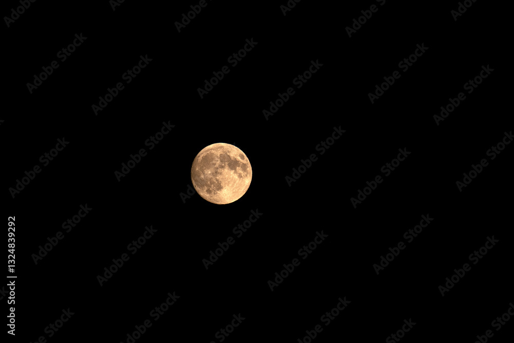 Big yellow moon on black sky