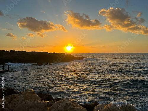 Sunset on Kissonerga beach in Paphos district of Cyprus on the Mediterranean Sea