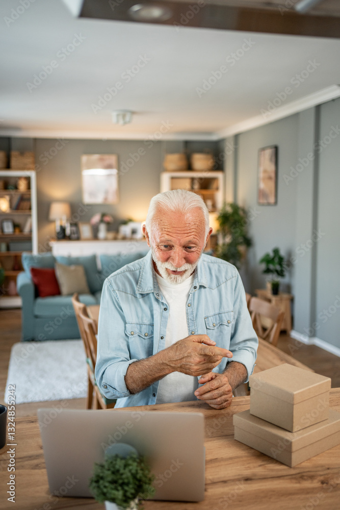 Senior man running small business from home office Senior man running small business from home office