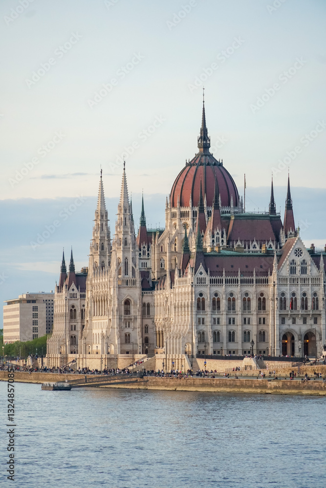 The Hungarian Parliament Building in Budapest, Hungary, stands majestically on the banks of the Danube River, showcasing its intricate neo-Gothic architecture The Hungarian Parliament Building in Budapest, Hungary, stands majestically on the banks of the Danube River, showcasing its intricate neo-Gothic architecture