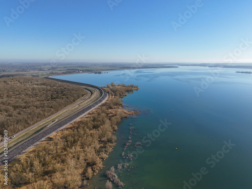 Lac d'orient and its vegetation in winter, reservoir lake on the Seine in the Aube département in France, in the nature reserve of the forêt d'orient in Champagne with a road beside it