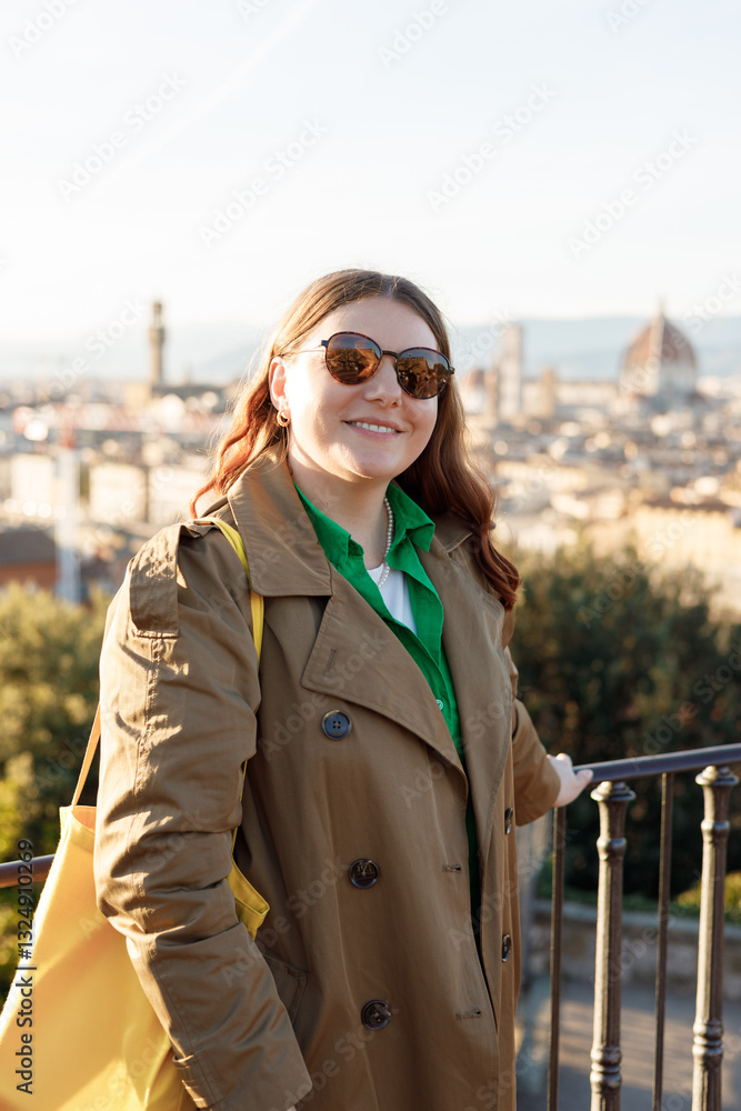 Young female tourist resting in Italy. Florence city landscape panoramic view. Stylish woman visiting Italian landmarks. Traveling Europe, Italy in spring, holidays concept.