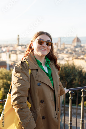 Obraz na płótnie Young female tourist resting in Italy. Florence city landscape panoramic view. Stylish woman visiting Italian landmarks. Traveling Europe, Italy in spring, holidays concept. w salonie