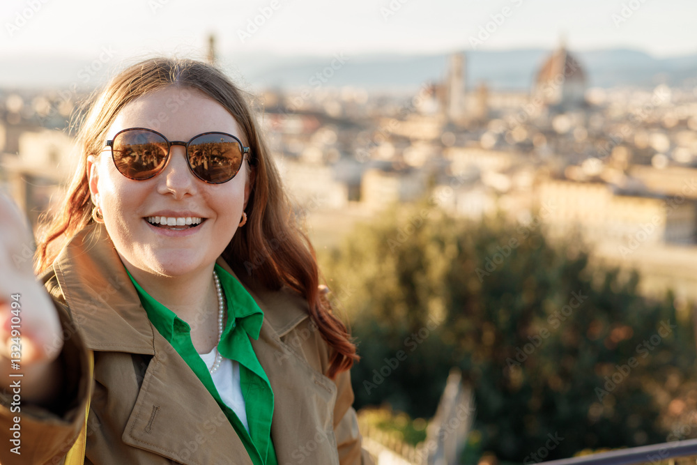 Young female tourist resting in Italy. Florence city landscape panoramic view. Stylish woman visiting Italian landmarks. Traveling Europe, Italy in spring, holidays concept.