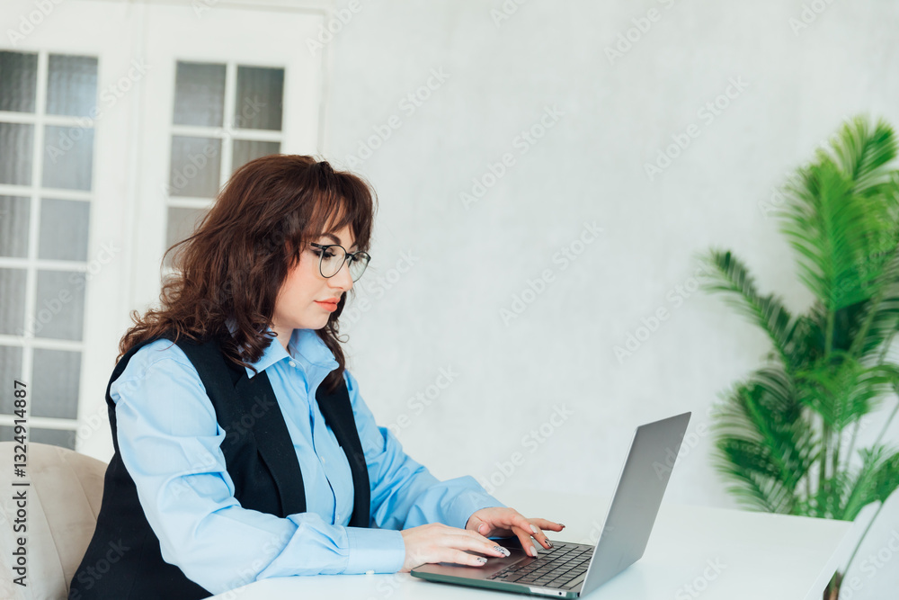 woman with laptop at desk in office training online woman with laptop at desk in office training online