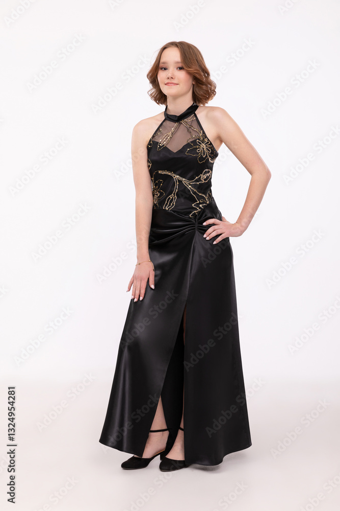 An Elegant Woman Dressed in a Stunning Black Evening Dress Featuring a Chic Slit An Elegant Woman Dressed in a Stunning Black Evening Dress Featuring a Chic Slit
