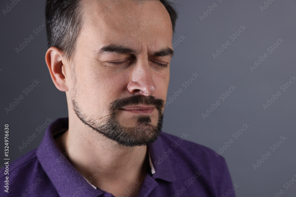 Sad man crying on grey background, space for text Sad man crying on grey background, space for text
