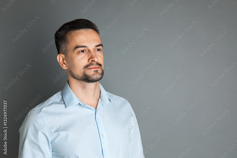 Obraz premium Portrait of handsome middle aged man on grey background, space for text