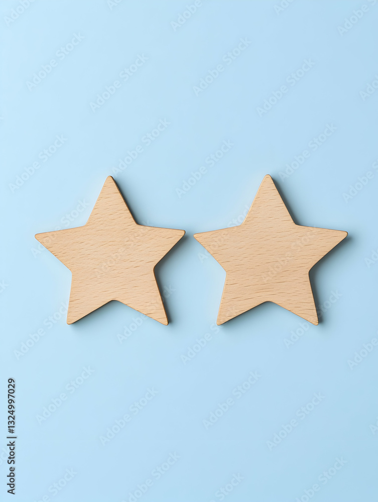 Two light beige wooden stars on a light blue background Two light beige wooden stars on a light blue background