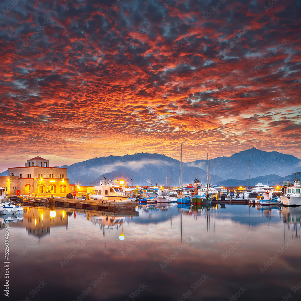 Impressive sunset view on boats in beautiful marina of Villasimius.