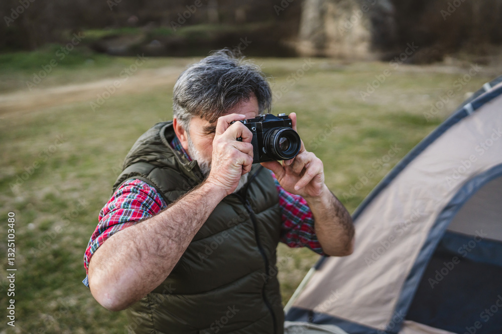 mature man take a picture of nature and landscape on camping trip mature man take a picture of nature and landscape on camping trip
