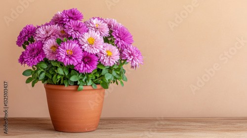 Wallpaper Mural Vibrant pink chrysanthemums in terracotta pot on wooden table against beige background Torontodigital.ca