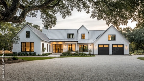 A modern farmhouse in crisp white, with a sleek gable roof and black-framed windows, sits prominently in the middle of a well-maintained front yard