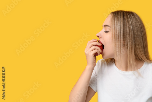 Young woman eating apple on...