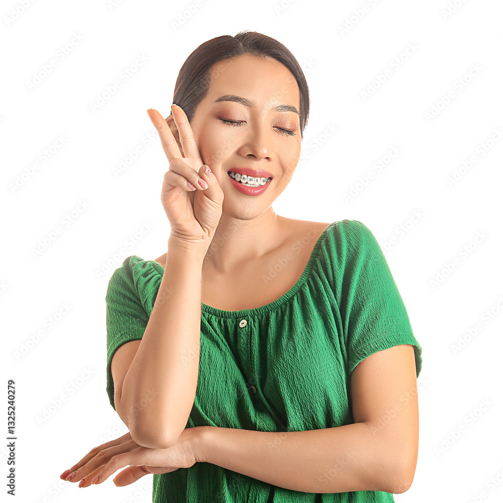 Portrait of pretty young Asian woman showing victory gesture on white background Portrait of pretty young Asian woman showing victory gesture on white background