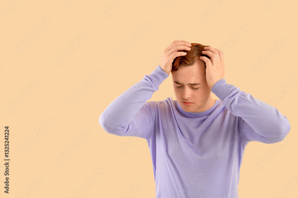 Young redhead man with problem of dandruff on beige background Young redhead man with problem of dandruff on beige background
