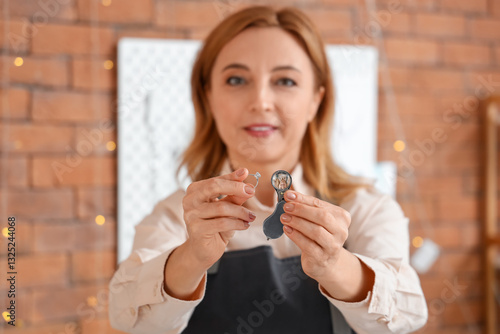 Female jeweler with magnifi...