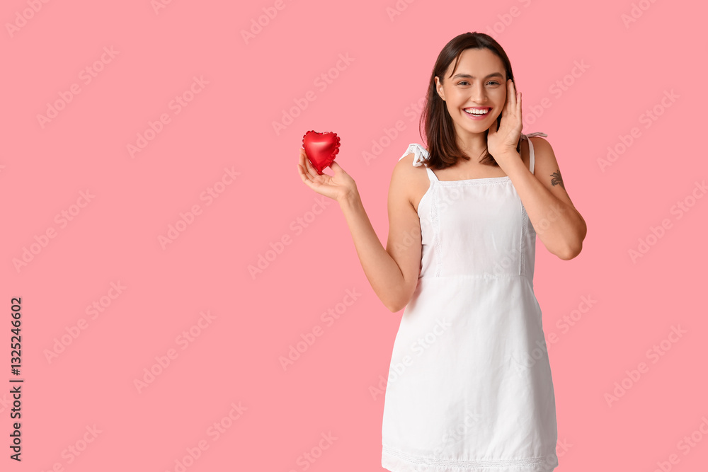 Beautiful young woman with air balloon in shape of heart on pink background. Valentine's Day celebration Beautiful young woman with air balloon in shape of heart on pink background. Valentine's Day celebration