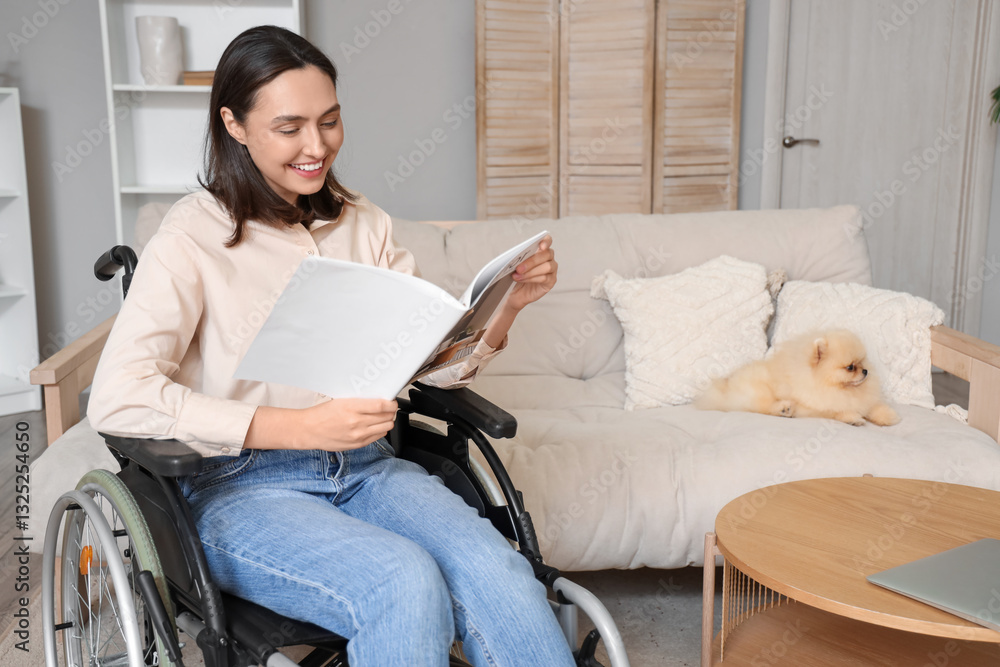 Φωτογραφία Happy young woman in wheelchair with Pomeranian dog reading magazine at home