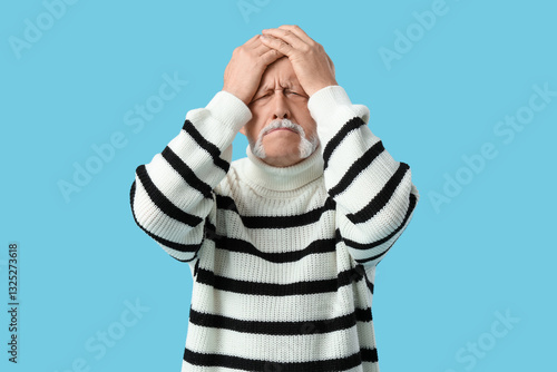 Shocked senior man on blue ...
