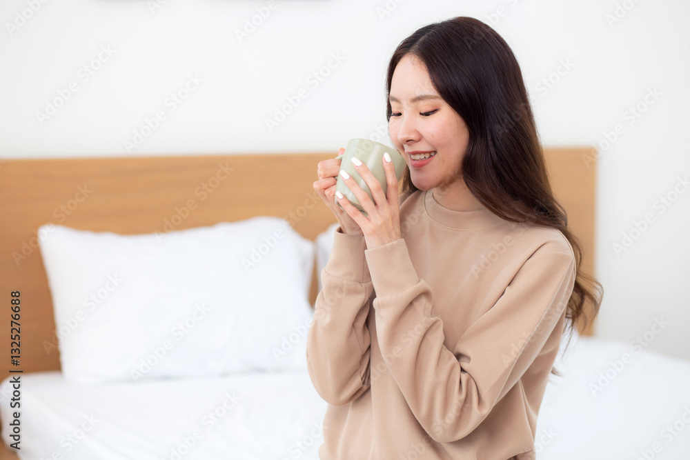 Young asian woman holding and drinking coffee in morning in bedroom at home for relaxation, woman drinking beverage with pleasure and freshness for health, relax and cozy, lifestyle concept. Young asian woman holding and drinking coffee in morning in bedroom at home for relaxation, woman drinking beverage with pleasure and freshness for health, relax and cozy, lifestyle concept.