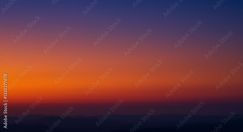 Fototapeta premium Fiery Sunset Over Silhouetted Mountains