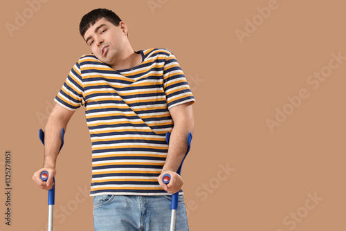 Young man with crutches on ...