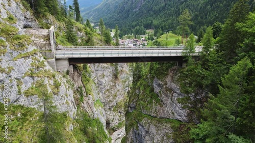Wallpaper Mural Drone view of bridge spanning rocky gorge in the Dolomites, Italy, lush greenery Torontodigital.ca