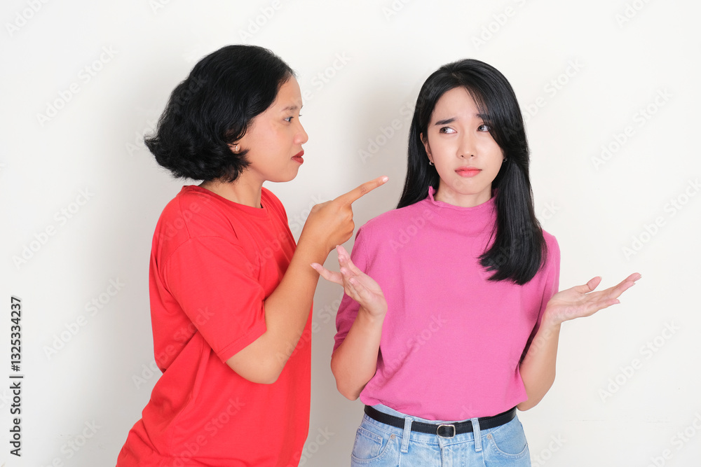 A woman blaming and pointing her friend with serious face expression A woman blaming and pointing her friend with serious face expression
