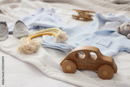 Toy car with baby clothes o...