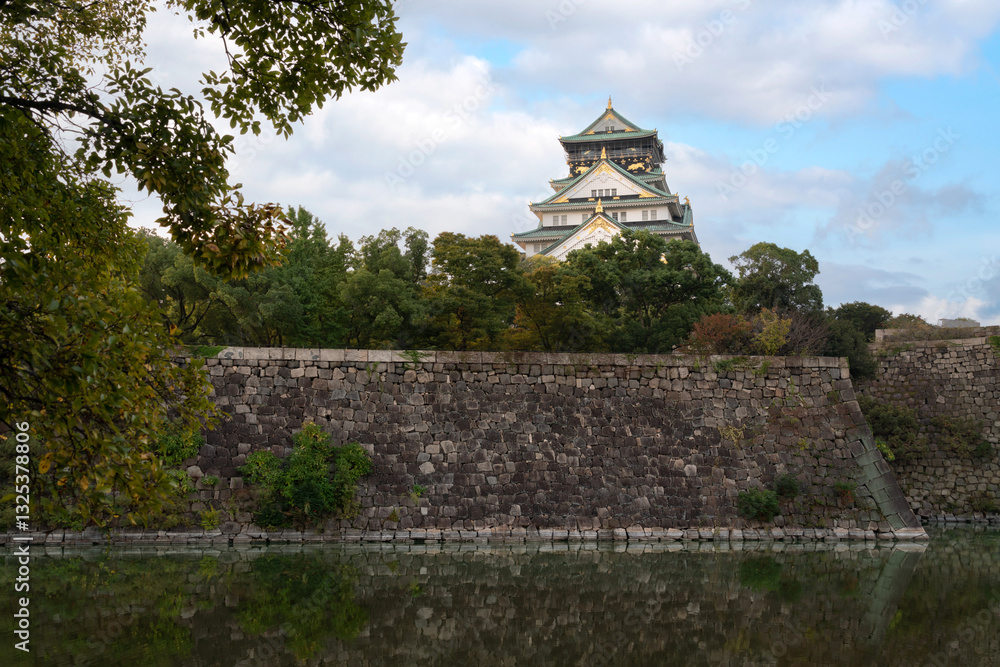 Osaka Castle on the background of the fortress wall on a sunny autumn morning, Osaka, Japan Osaka Castle on the background of the fortress wall on a sunny autumn morning, Osaka, Japan