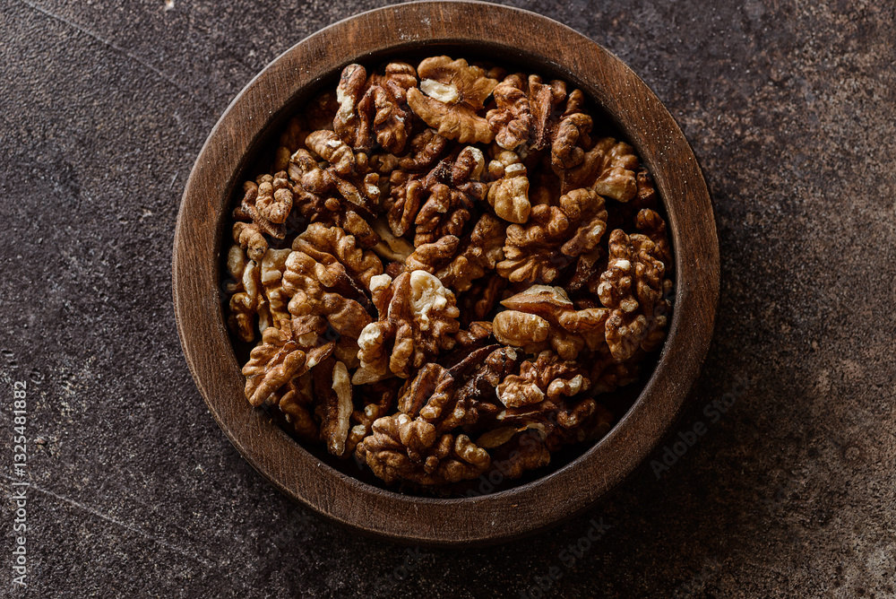 organic raw walnuts in a wooden bowl organic raw walnuts in a wooden bowl