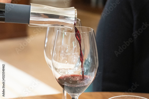 pouring red wine into glass