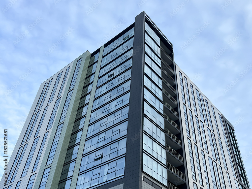 The exterior of a modern multi-storey apartment building is the facade, windows and balconies. Beautiful stylish new area, decorated in an unusual style. urban landscape, urbanism. The exterior of a modern multi-storey apartment building is the facade, windows and balconies. Beautiful stylish new area, decorated in an unusual style. urban landscape, urbanism.